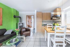 a living room with a couch and a table at Ferienhaus Kikki in Friedrichskoog-Spitze
