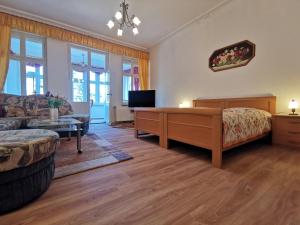 a living room with a bed and a couch at Villa Adler- Seeblick in Ahlbeck