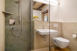 a bathroom with a toilet and a sink and a shower at Landluft Ferien - Wohnung Morgentau in Heiligenberg +20 photos