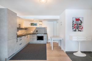 a kitchen with white walls and stainless steel appliances at In Bayern in Warngau +16 photos