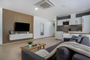 a living room with a couch and a tv at Eclipse in Puerto del Rosario