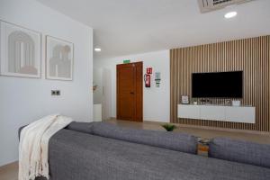 a living room with a couch and a flat screen tv at Eclipse in Puerto del Rosario