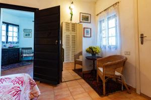 a bedroom with a bed and a table and a door at Casa Country in Capoliveri
