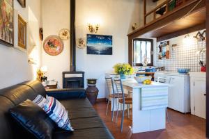 a living room and kitchen with a couch and a table at Casa Country in Capoliveri