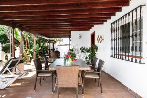a dining room with a table and chairs on a patio at Casa Colleen in Puerto del Carmen