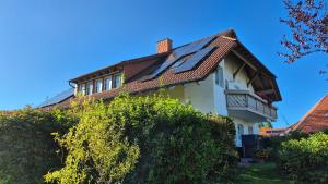 a house with a solar roof on top of it at Ferienwohnung Haus Doris in Rickenbach