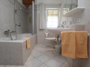 a bathroom with a sink and a toilet and a bath tub at Ferienwohnung Haus Doris in Rickenbach +30 photos