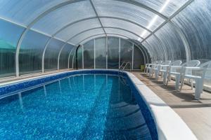 a swimming pool in a dome with chairs around it at Valle De Juarros in San Adrián de Juarros