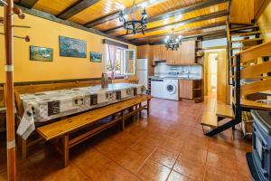a kitchen with a long bench in a room at Valle De Juarros in San Adrián de Juarros