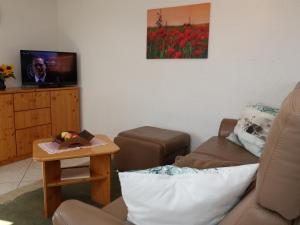 a living room with a couch and a table at Ferienwohnung Haus Doris in Rickenbach
