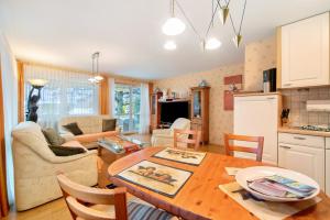 a kitchen and living room with a wooden table at Ferienwohnung Baier in Überlingen