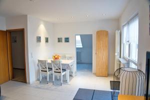 a kitchen and dining room with a table and chairs at Kunibert, 120 qm in Stockach