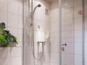a bathroom with a shower with a glass door at Kunibert, 120 qm in Stockach +13 photos