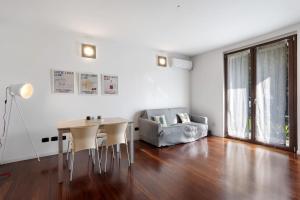 a living room with a table and a couch at vb home brianza in Costa Masnaga