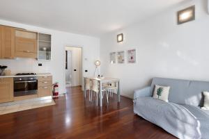 a living room with a couch and a table at vb home brianza in Costa Masnaga +12 photos