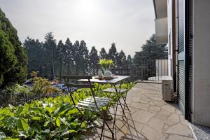 a patio with a table and chairs on a balcony at vb home brianza in Costa Masnaga