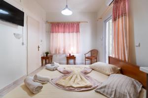 a bedroom with a bed with a dress on it at Nikiana Club - Studio 1 in Nikiana