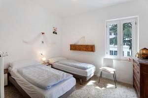 a bedroom with two beds and a window at Casa romantica in Ispra
