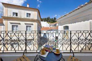 a table with a book and glasses on a balcony at Villa Xique 9 in Monchique