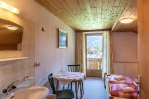 a bathroom with a sink and a table and a window at Ferienwohnung Oberangerhof in Kaltenbach +25 photos
