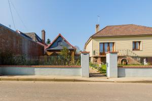 a house with two gates in front of a street at Maison à Saint-Blimont in Saint-Blimont