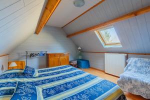 a bedroom with two beds in a attic at Maison à Saint-Blimont in Saint-Blimont