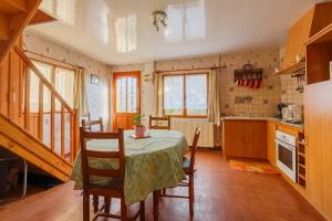 a kitchen with a table and chairs in a room at Maison à Saint-Blimont in Saint-Blimont