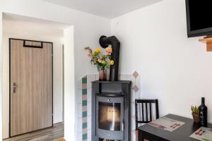 a room with a fireplace and a table with flowers at Haus Auner Top 5b in Westendorf