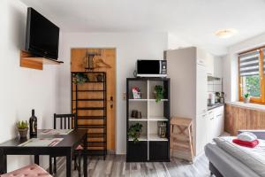 a small living room with a table and a kitchen at Haus Auner Top 5b in Westendorf