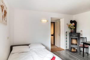a bedroom with a bed and a fireplace at Haus Auner Top 5b in Westendorf