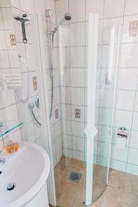 a bathroom with a shower and a toilet and a sink at Haus Piratennest in Grömitz +9 photos