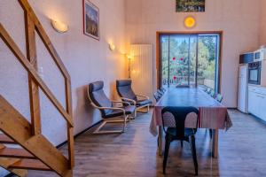 a room with a table and chairs and a staircase at Apt Framboise Les Monts d'olmes in Montferrier +13 photos