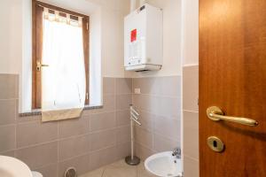 a bathroom with a toilet and a sink and a window at Papà Giuseppe La Stalla in Cortona +16 photos