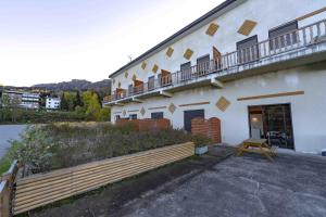 a building with a balcony and a bench next to it at Apt Framboise Les Monts d'olmes in Montferrier