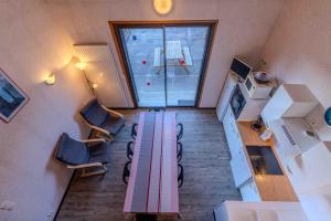 a room with a table in the middle of a kitchen at Apt Framboise Les Monts d'olmes in Montferrier