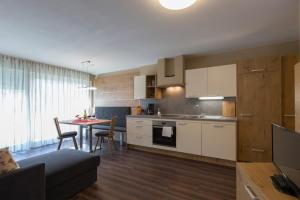 a kitchen and a living room with a table at Alpenblick Nr 6 in Campo Tures +10 photos
