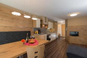 a kitchen with a wooden table and a dining room at Alpenblick Nr 6 in Campo Tures