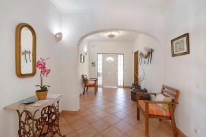 a living room with a table and a mirror at Casa do Barrocal in Almancil +19 photos