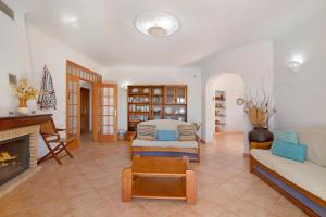 a living room with a couch and a fireplace at Casa do Barrocal in Almancil