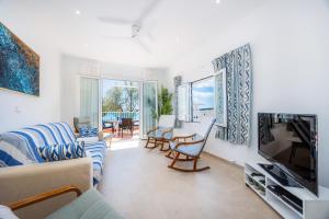 a living room with a couch and a tv at Casa Antonia in Cala Millor