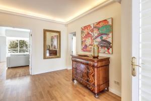 an empty living room with a dresser and a painting on the wall at Villa Bellver in Palma de Mallorca +16 photos