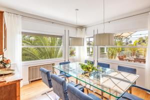 a dining room with a glass table and chairs at Villa Bellver in Palma de Mallorca