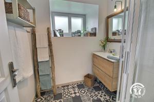 a bathroom with a sink and a mirror at Le passé composé in Ploubazlanec +43 photos