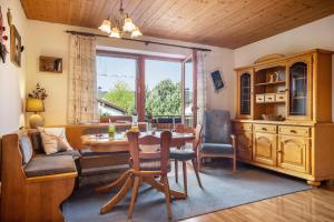 a living room with a table and chairs and a couch at Gästehaus Erd - Fewo Grünten in Wertach