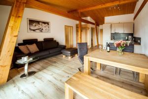 a living room with a couch and a table at Ferienwohnung Aichem in Radolfzell am Bodensee