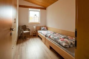 a small room with a bed and a window at Ferienwohnung Aichem in Radolfzell am Bodensee