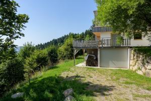a house on the side of a hill with a balcony at Refuge Mil100 Chalet-spa Luxe 5 in Metzeral