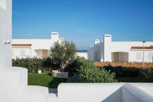 a view of a white building with a yard at Villa Terry in Ostuni