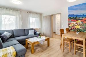 a living room with a couch and a table at Li-Do-Bo 01 in Herdwangen-Schönach