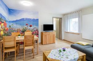 a living room with a painting on the wall at Li-Do-Bo 01 in Herdwangen-Schönach